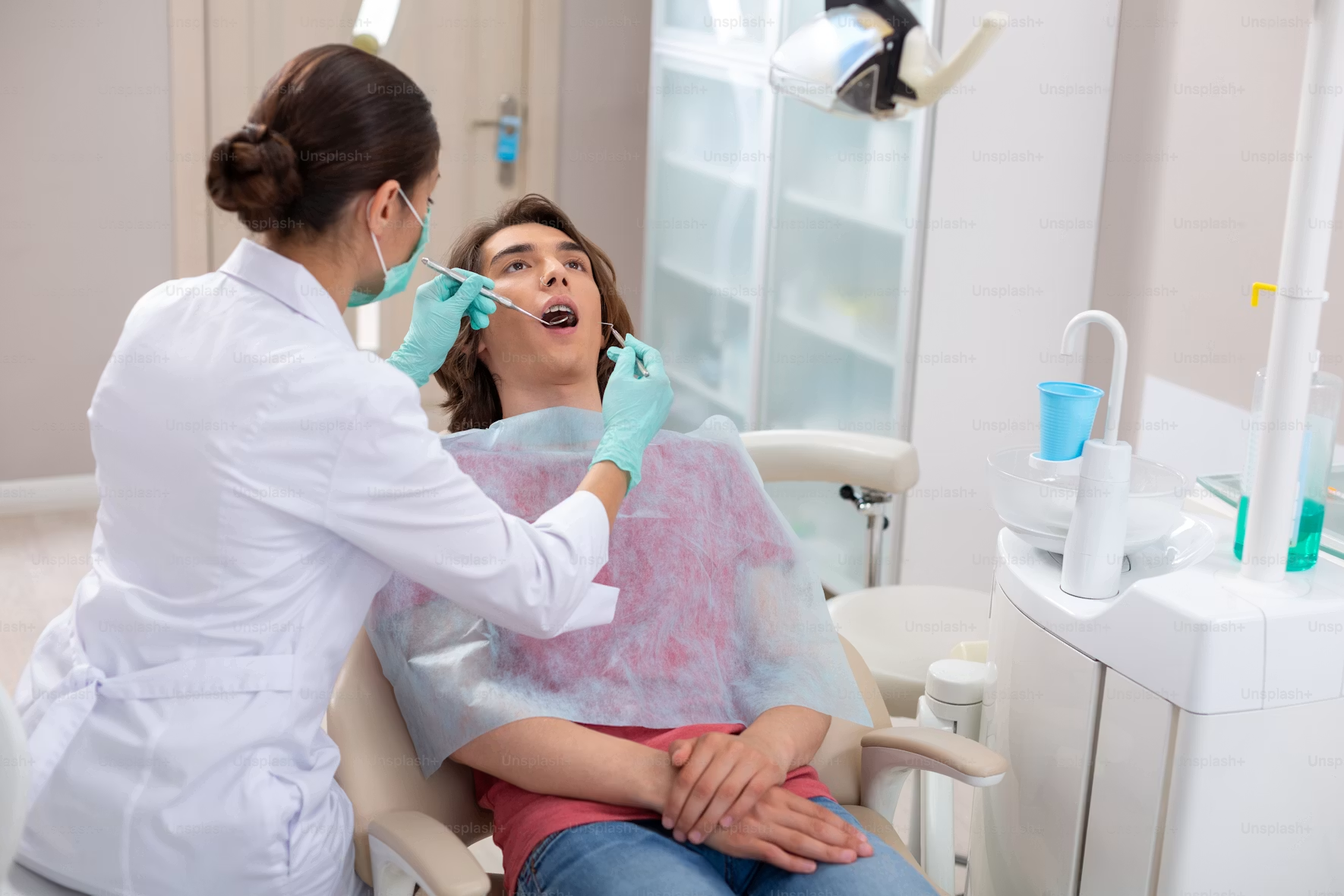 Dentist treating a patient under the NHS pathway